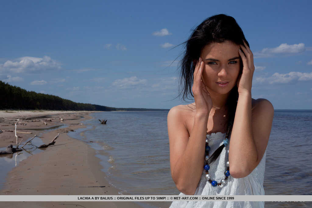 Exposing her dark hair, teen Lachia A goes completely nude on the seashore hammock