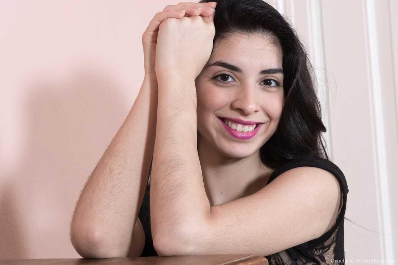 Dark haired hairy Ornella bends over to flaunt her super furry pussy bush! - Ornella