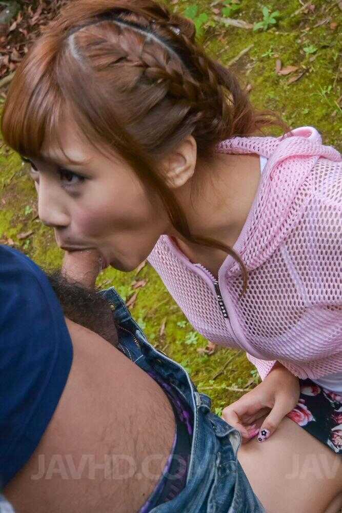 Japanese redhead Anna Anjo kneels on a lawn and blows a tiny cock in her mouth while enjoying the fresh air