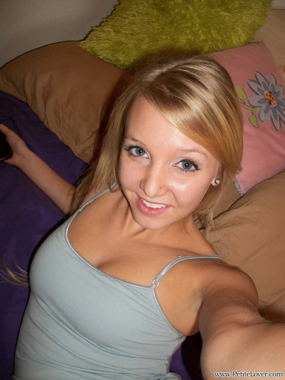 Cute teen Elle Blue displays her hairless pussy in a homemade selfie on her bed - Elle Blue