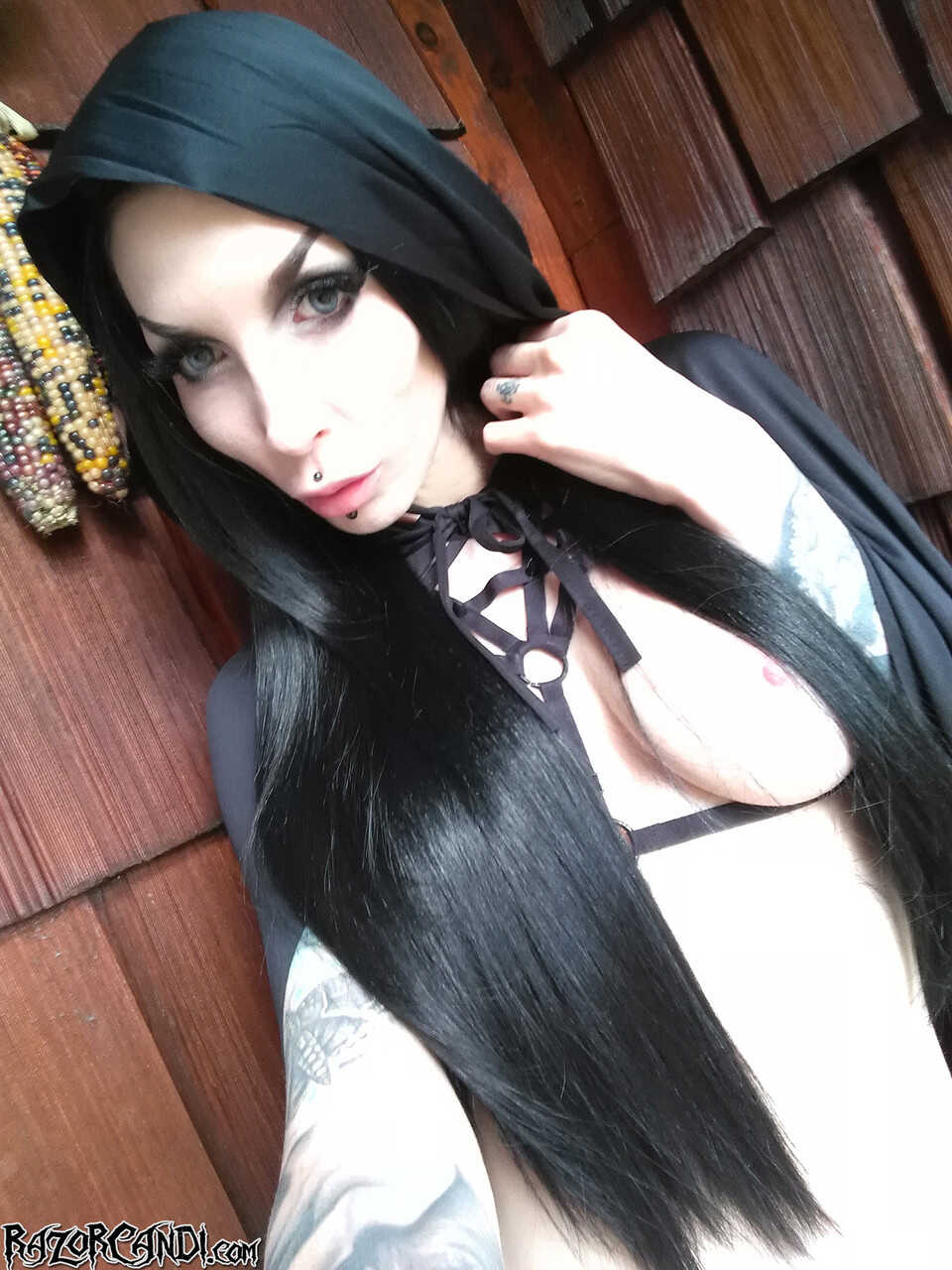 Gothic MILF takes a bite out of her phat ass while surrounded by pumpkins - Razor Candi