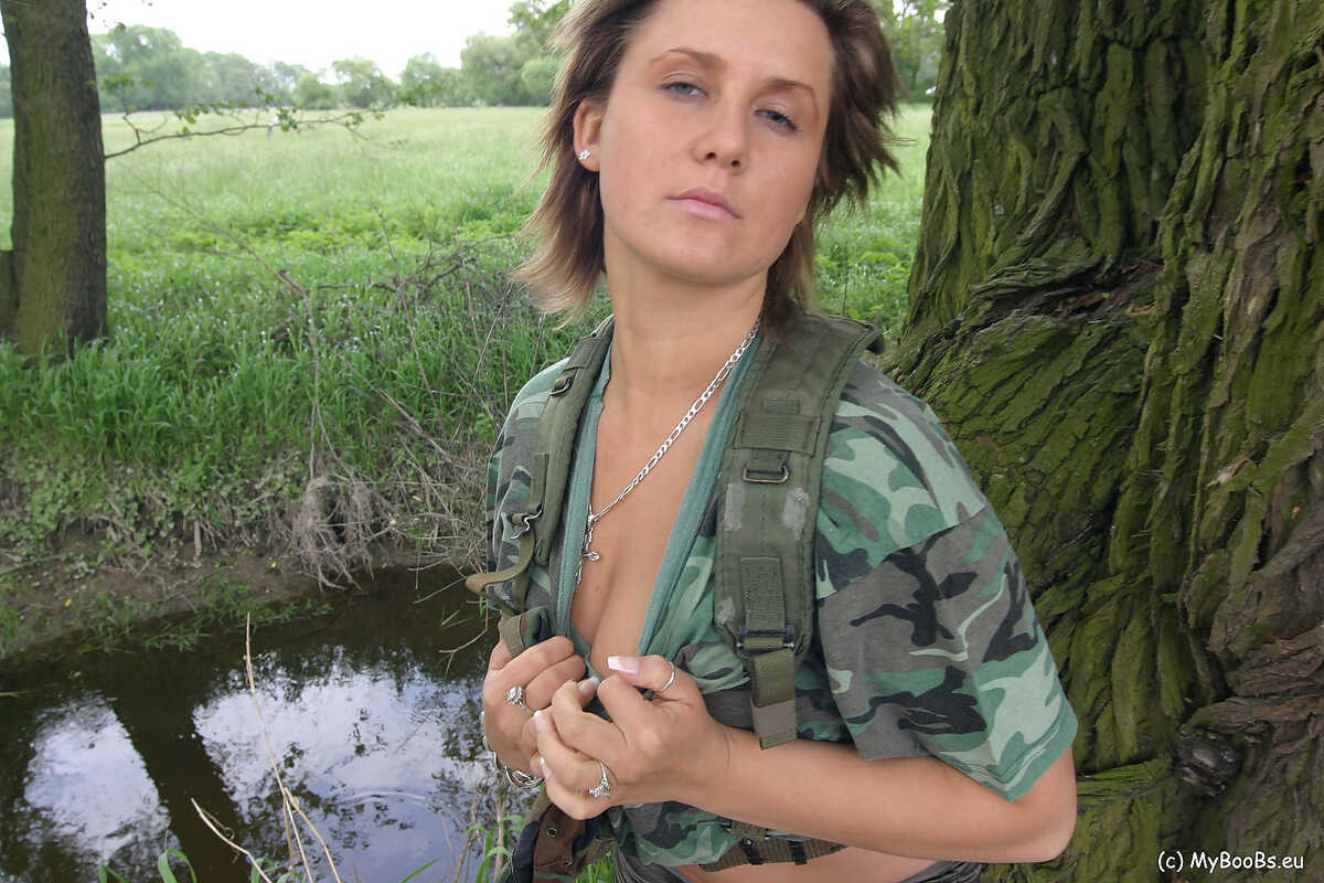 Solo girl Lea Ticia fondles her large boobs amid trees in military attire - Lea Ticia
