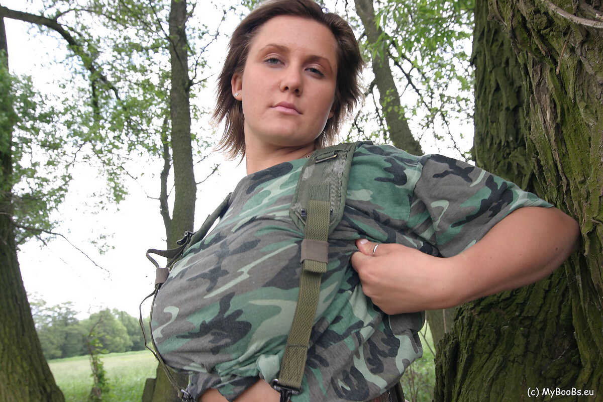 Solo girl Lea Ticia fondles her large boobs amid trees in military attire - Lea Ticia