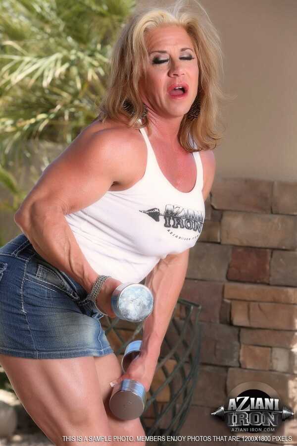Older blonde bodybuilder Wanda Moore flexes on the patio before masturbating   Mature Blonde Muscle Goddess Flexes and Jer...