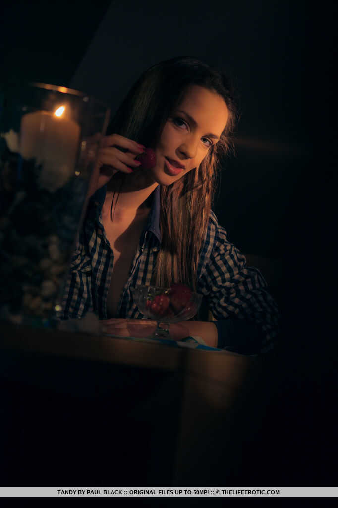 Pretty brunette Tandy gets naked by candlelight while eating strawberries - Tandy