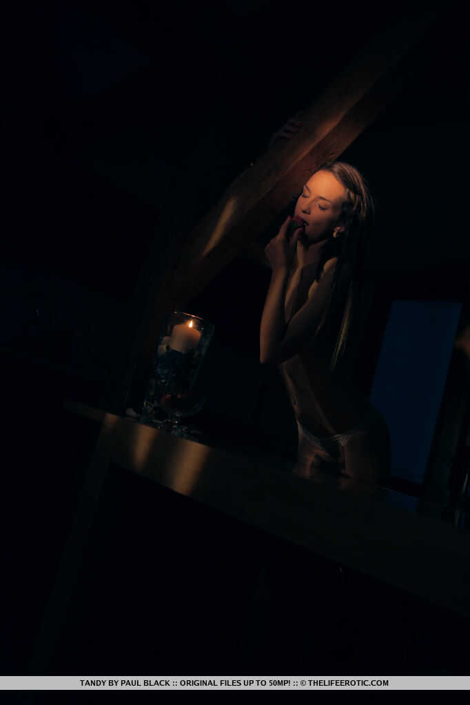 Pretty brunette Tandy gets naked by candlelight while eating strawberries - Tandy