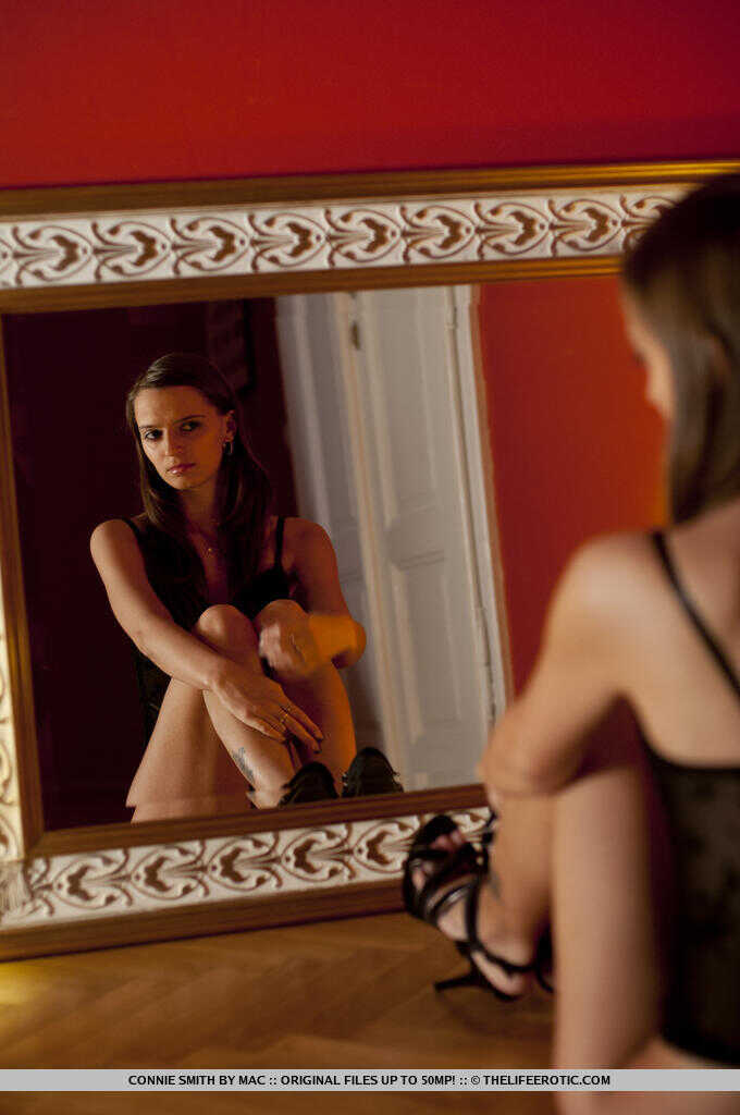 Connie Smith, tall brunette goddess, poses seductively in front of a mirror wearing her high heels. - Connie Smith