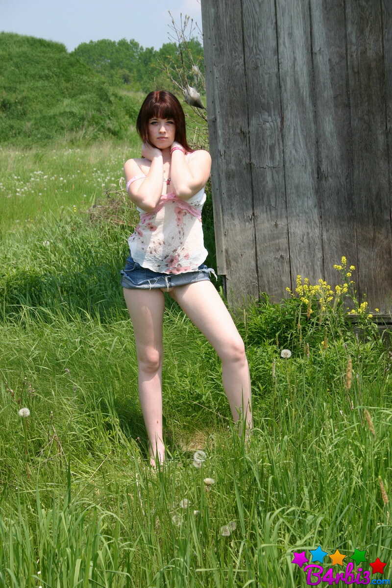 Teen amateur B4rbi3 shows off her busty boobs behind the barn in a denim mini-skirt.