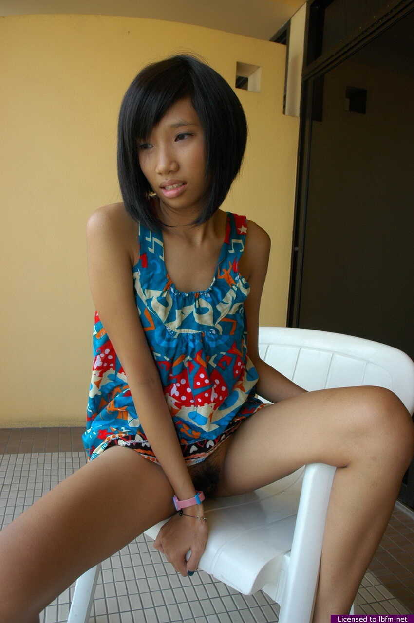 Asian Pat spreads her legs wide on the balcony to show off her hairy bush!