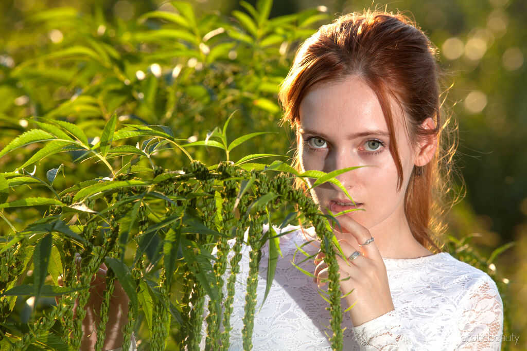 Young redhead May shows off her bald pussy in the dirt while butt naked on a solo adventure - May