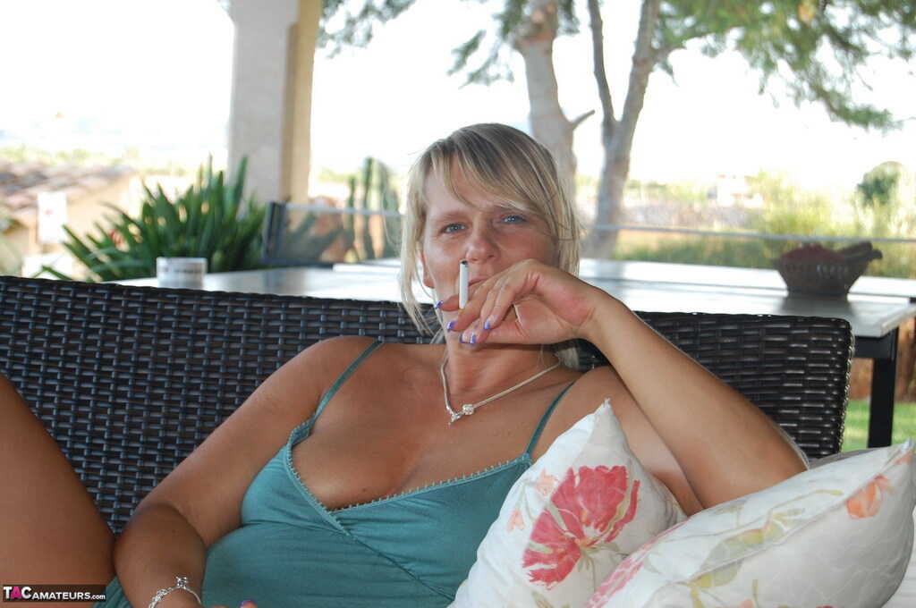 Tanned mature slut Sweet Susi smoking as she spreads pussy and flaunts nude ass while enjoying her middle aged blonde beau...