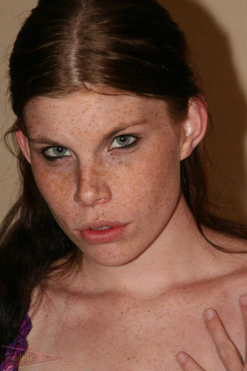 Redhead amateur Holly Lane shows off her shaved vagina and spreads her natural tits on her bed for a solo session of self-...