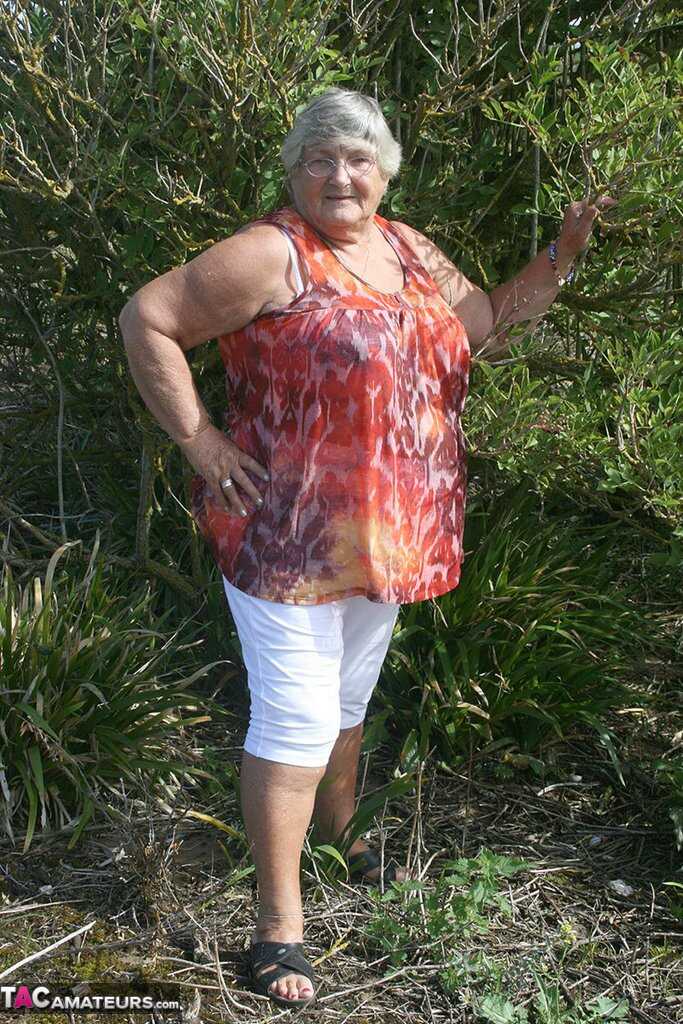 Granny's Garden of Eden Obese nan Grandma Libby strips totally naked out by evergreen trees - Grandma Libby