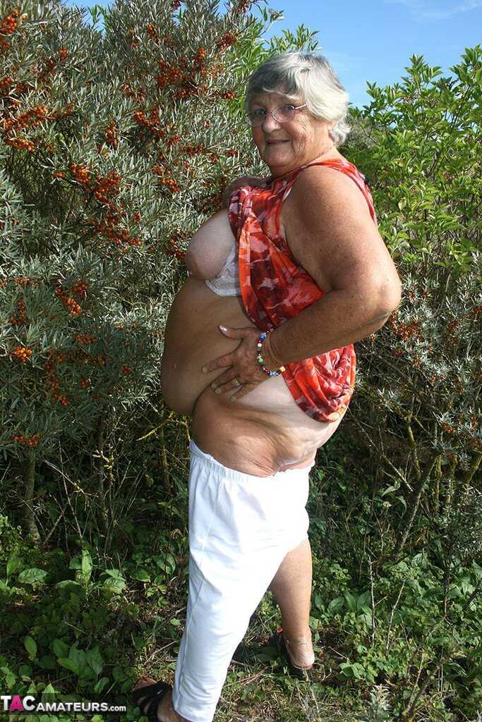 Granny's Garden of Eden Obese nan Grandma Libby strips totally naked out by evergreen trees - Grandma Libby