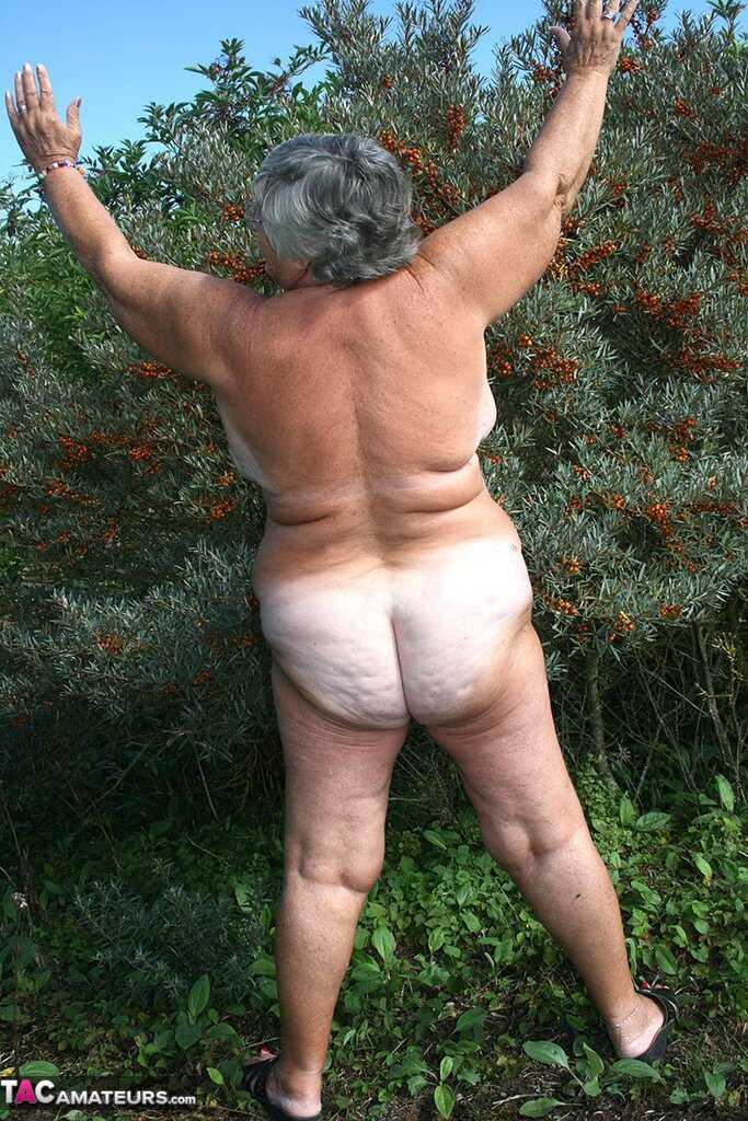 Granny's Garden of Eden Obese nan Grandma Libby strips totally naked out by evergreen trees - Grandma Libby