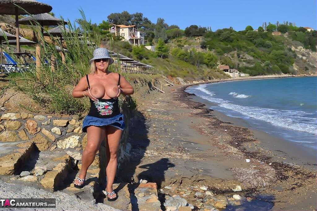 Mature Beach Slut Gets Naked and Wet: Huge Boobs on Display in the Sand! - Nude Chrissy
