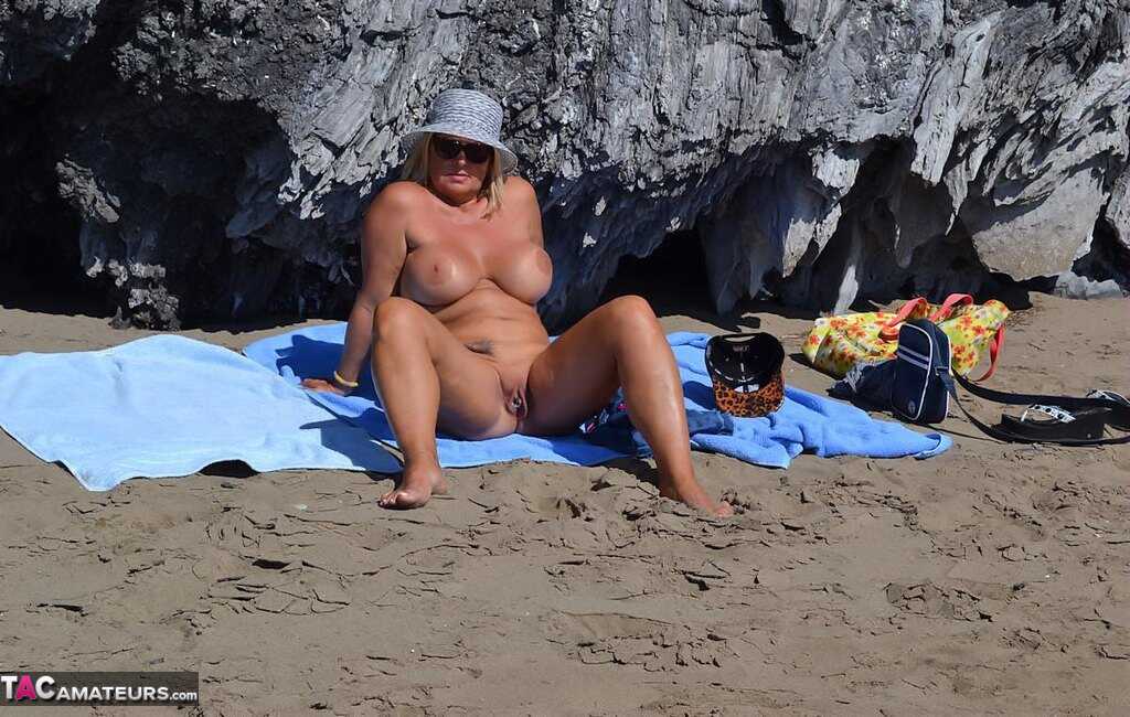 Mature Beach Slut Gets Naked and Wet: Huge Boobs on Display in the Sand! - Nude Chrissy