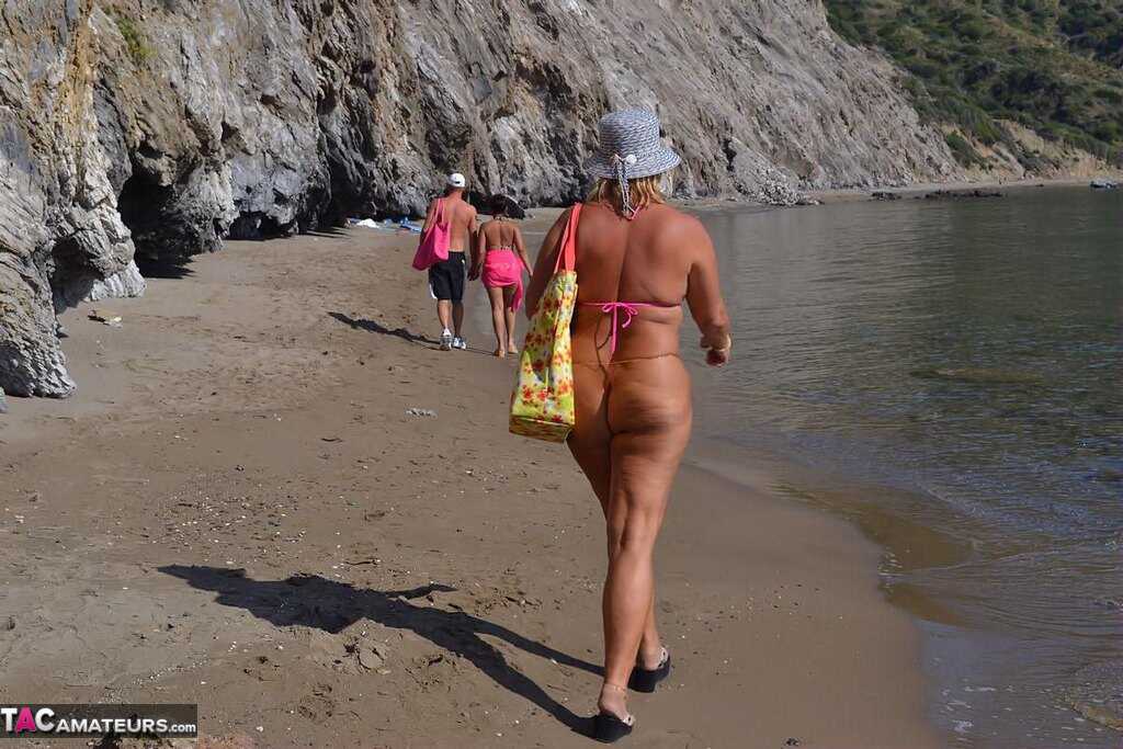 Mature Beach Slut Gets Naked and Wet: Huge Boobs on Display in the Sand! - Nude Chrissy