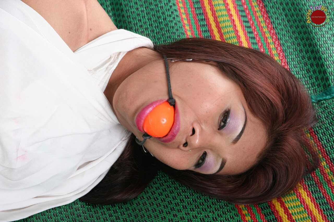Ball-Gagged Asian Beauty Hogtied and Helpless on a Bed in a Dress with Perfect Feet - 