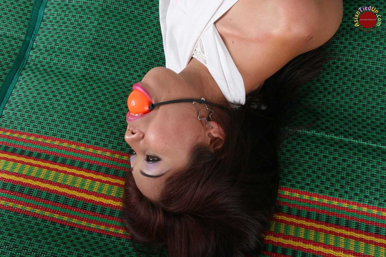 Ball-Gagged Asian Beauty Hogtied and Helpless on a Bed in a Dress with Perfect Feet - 