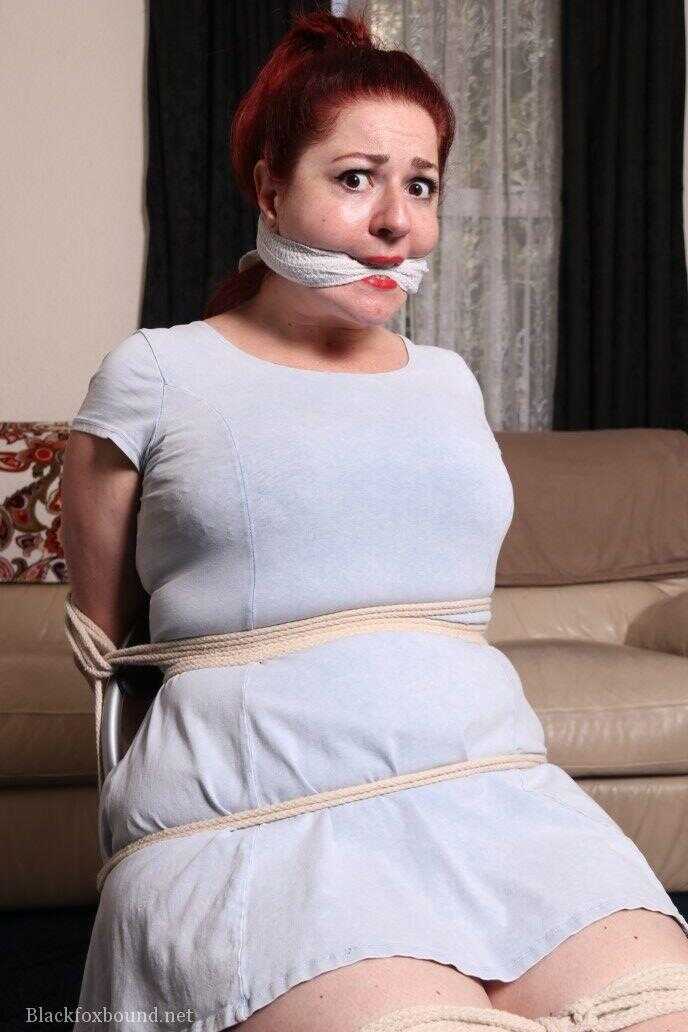 Fat British woman is tied to a chair with clothes on while cleave gagged