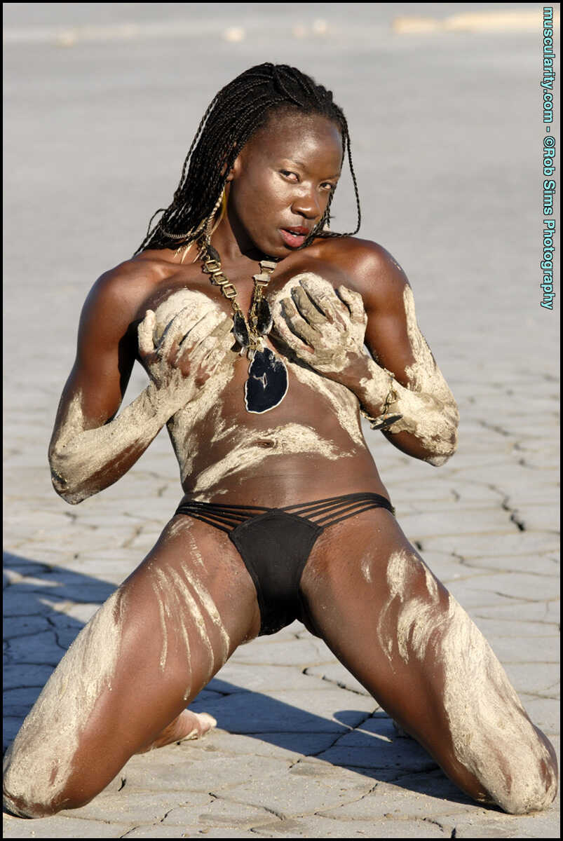 Ebony Bodybuilder Camille Elizabeth Covers Her Toned Body in the Sand with a Seductive Smile - Camille Elizabeth