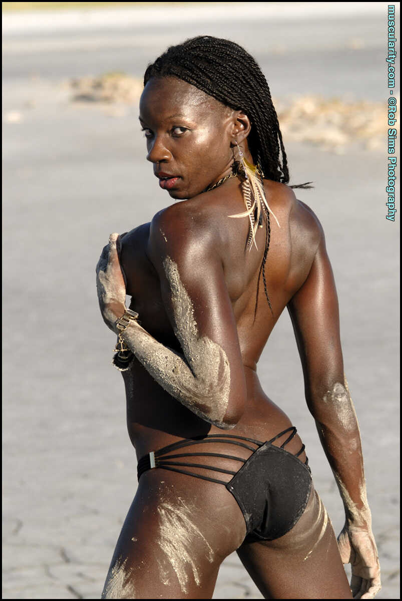 Ebony Bodybuilder Camille Elizabeth Covers Her Toned Body in the Sand with a Seductive Smile - Camille Elizabeth
