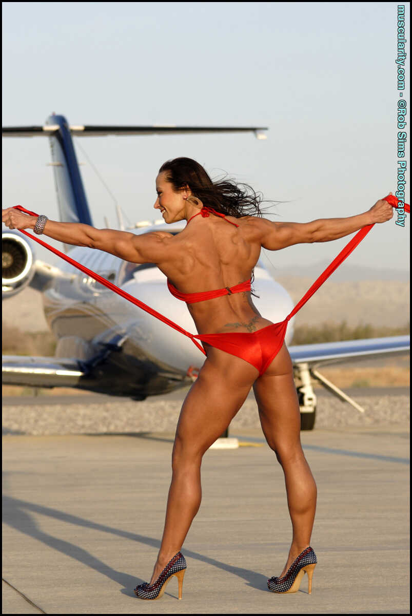 Hot Muscular Patricia Beckman Poses in a Red Bikini in Front of a Private Jet, While Wearing MILF High Heels - Patricia Be...