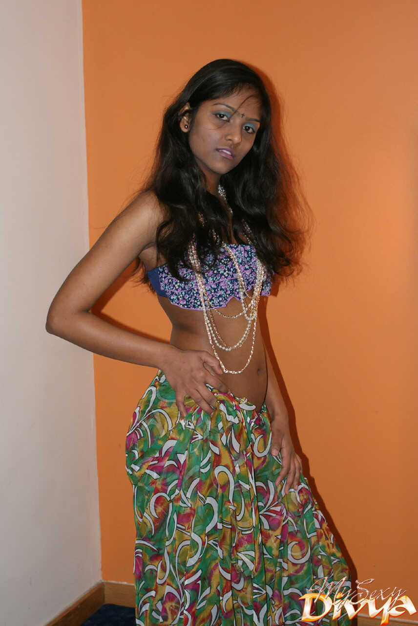 Slender Indian amateur Divya Yogesh exposes her natural small tits as she gets naked and plays with them in bed - Divya Yo...