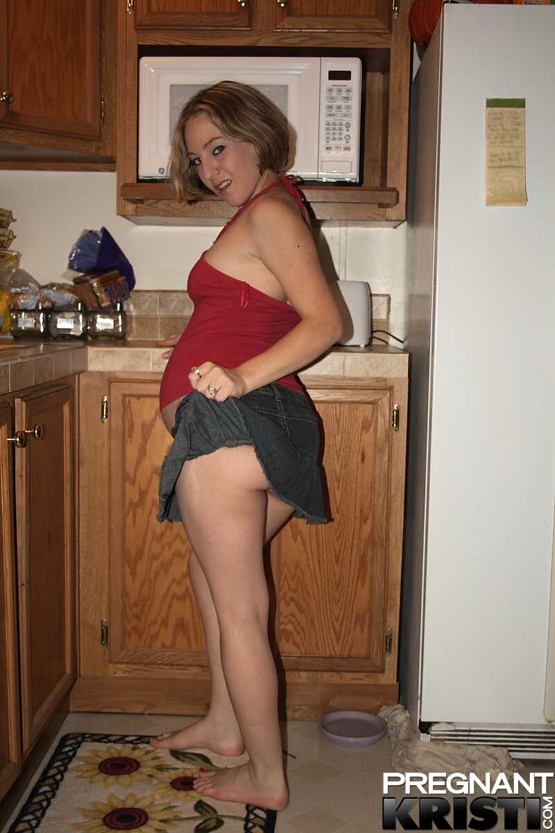 Barefoot Kristi's pregnant pussy in the kitchen