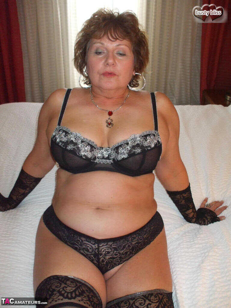 Plump older woman Busty Bliss flaunts her natural tits in arm socks and undies while getting down on all fours to show off...