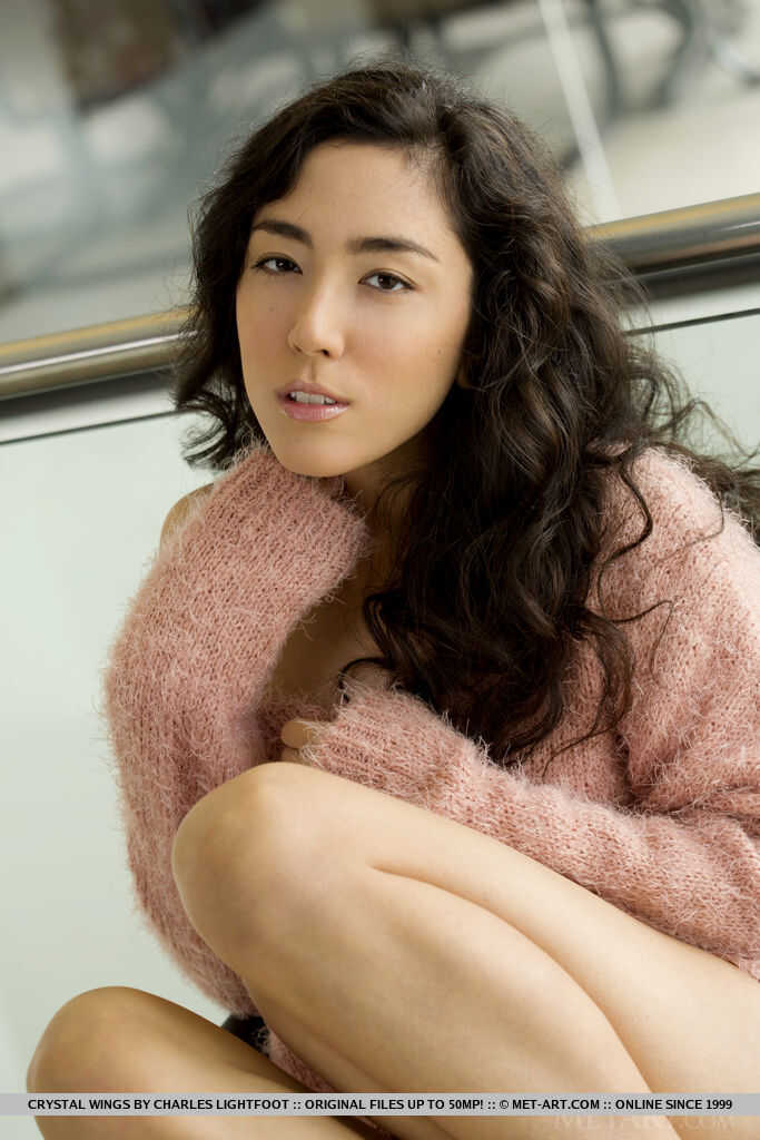 Crystal Wings strips off her sweater and panties to reveal her nude body, exposing her Asian ass and feet while posing sed...