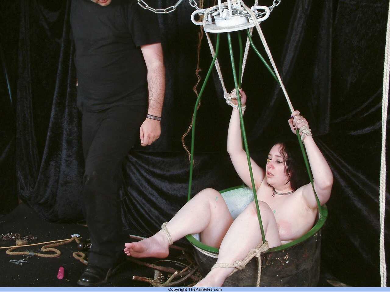 Chubby girl's needle-pierced face takes on a new meaning as her feet are tied down and used for some hardcore bondage...