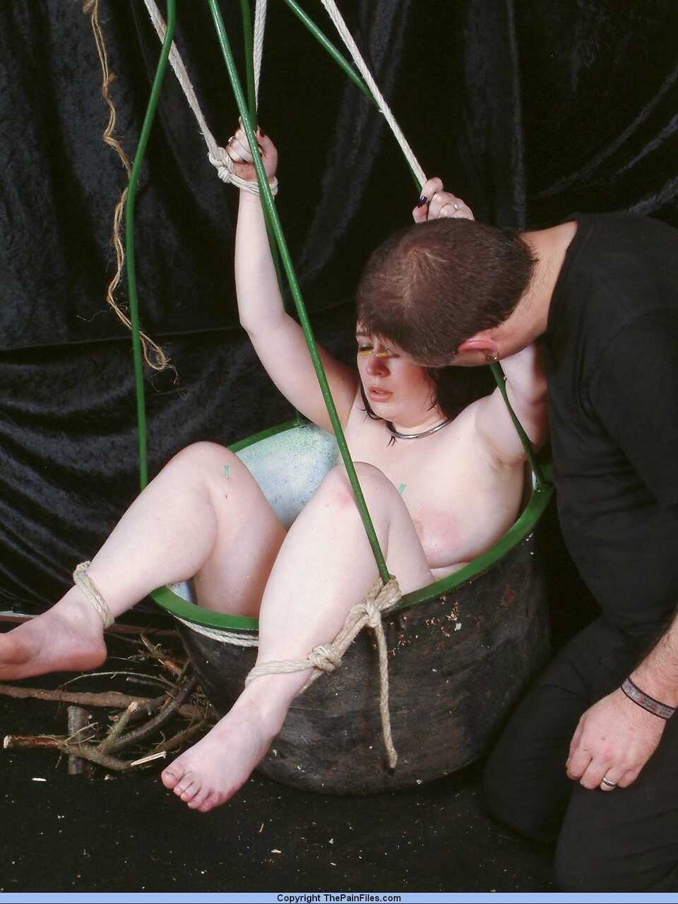 Chubby girl's needle-pierced face takes on a new meaning as her feet are tied down and used for some hardcore bondage...
