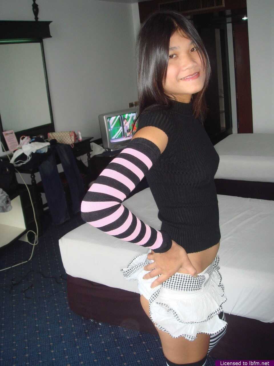 Young Asian Girl's Tight Pussy Exposed as She Disrobes to Arm Socks and Thigh Highs