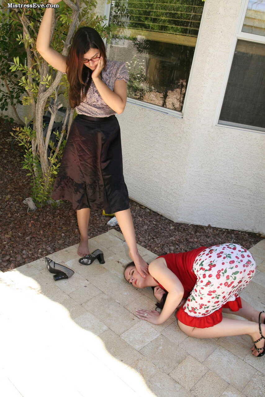 Brunette chick goes down on her lesbian lover's soapy feet on a sunny patio - 