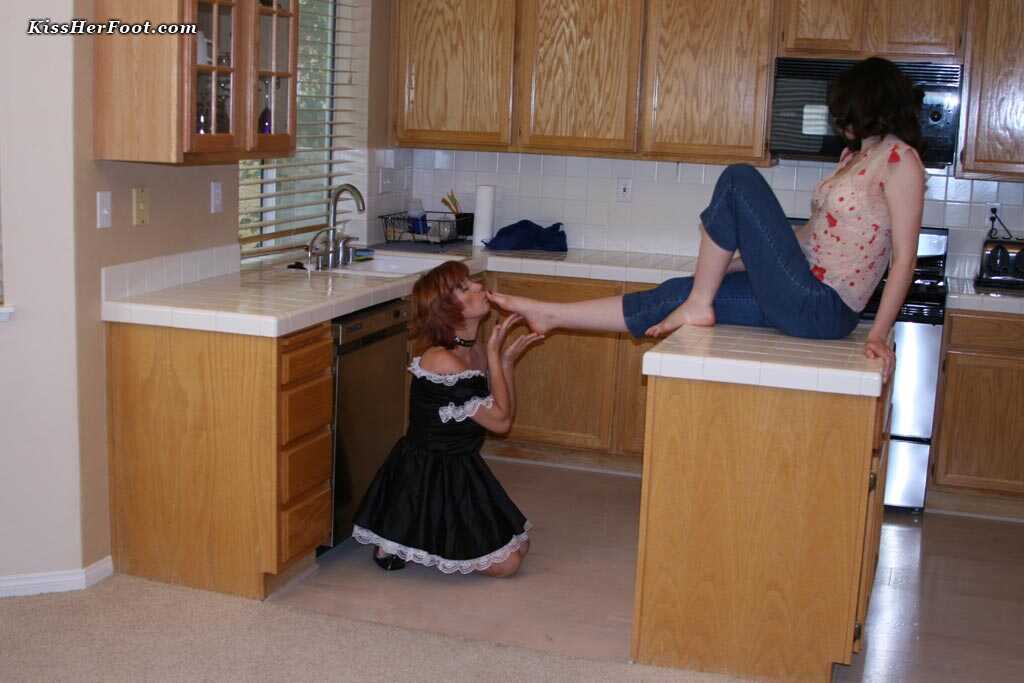 Brunette chick gets her long, sexy toes licked and sucked by a horny redheaded maid named Calliste - Calliste