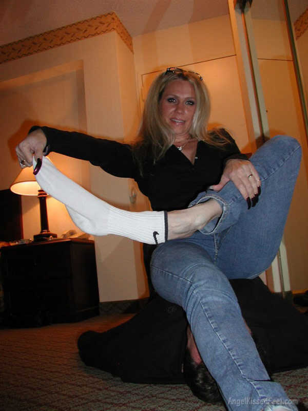 A Dominating Blonde Goddess Takes Off Her Socks While Having Her Mature Feet Worshiped and Smothered with Jeans - 