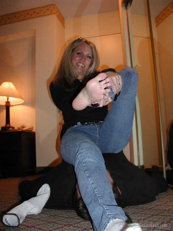 A Dominating Blonde Goddess Takes Off Her Socks While Having Her Mature Feet Worshiped and Smothered with Jeans - 