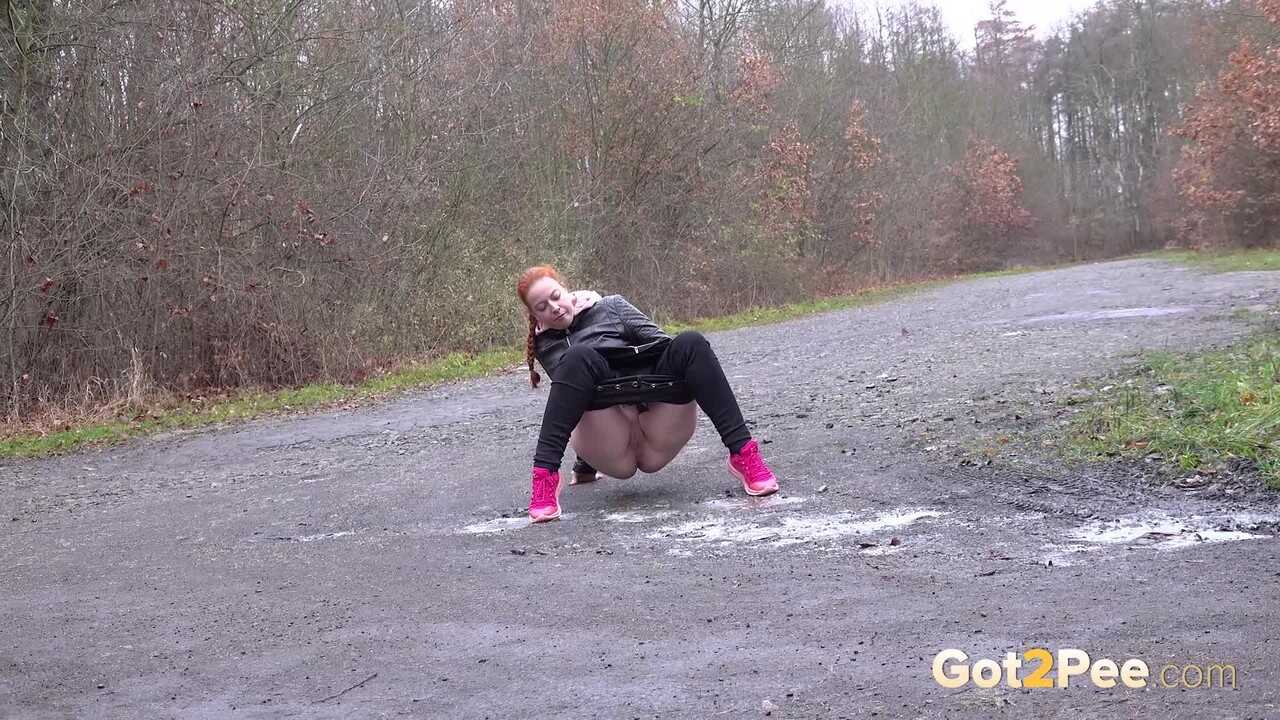 Piss-lovers delight: Pale redhead Redfox taking a public piss on a rural road during a dull day!