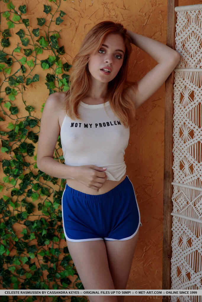 Hairy redhead Celeste Rasmussen disrobes and spreads her tight teen ass on a wicker chair while posing nude with small tit...
