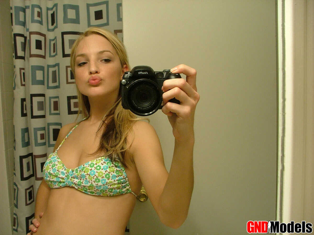 Blonde teen Marilyn takes mirror selfies while wearing a three-piece swimsuit, and it's the hottest thing you'll...