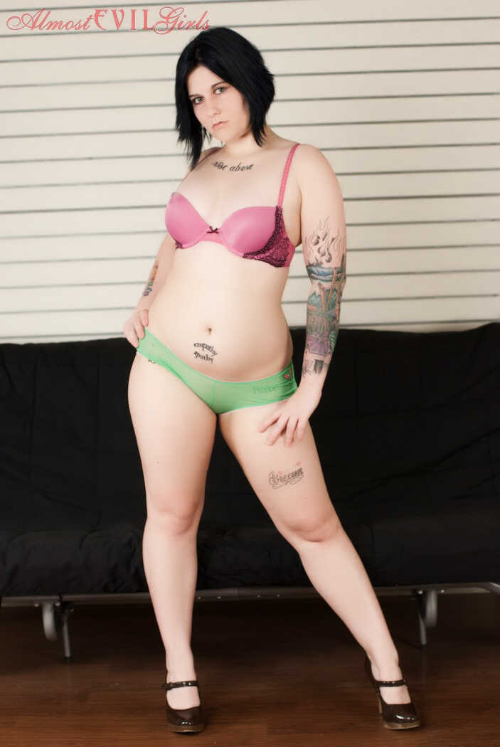 Tattooed plumper Green Eyed teases her thick legs and fat ass in a naughty lingerie show before stripping naked for the camera