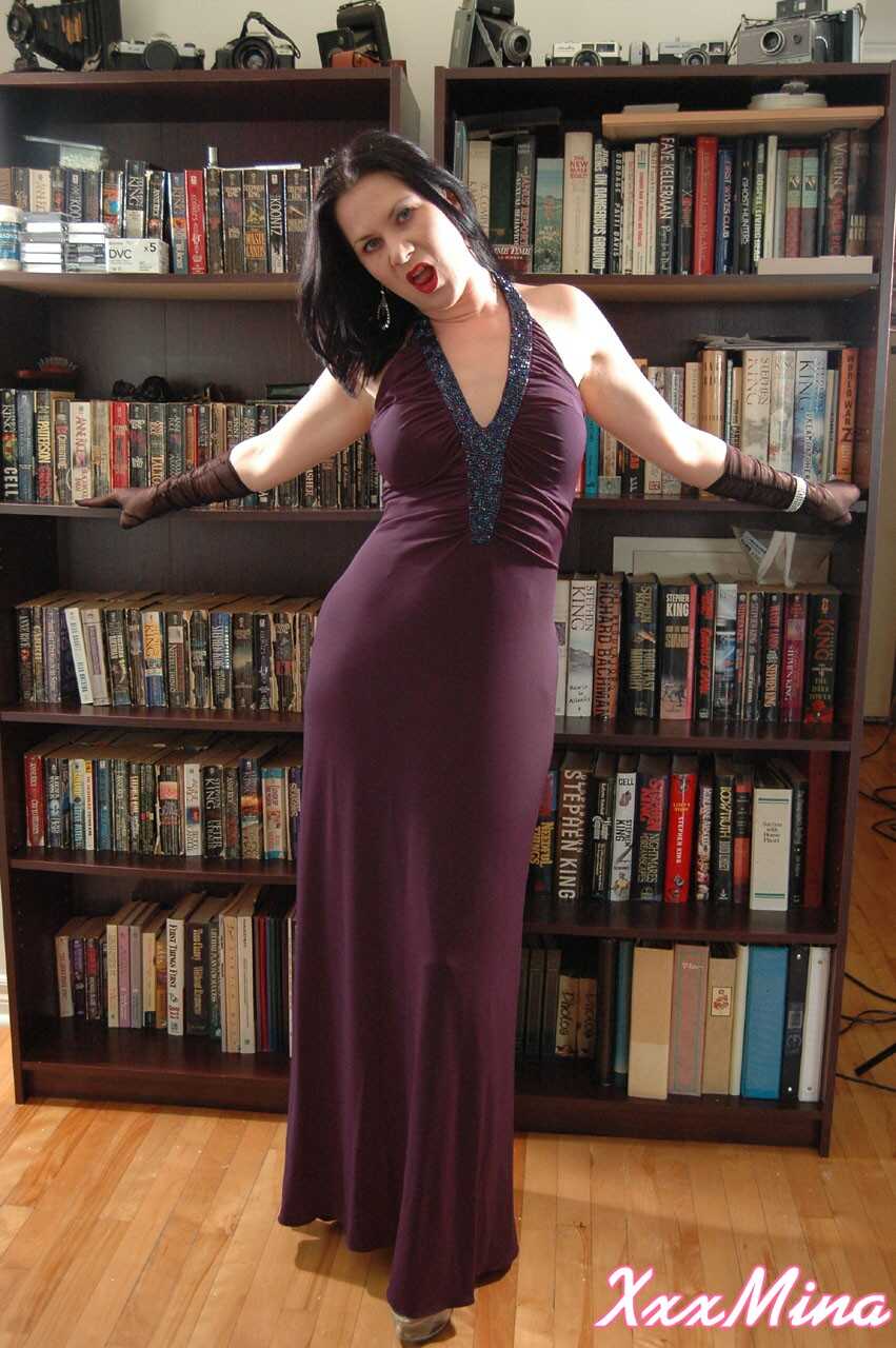 Mature Mina Gorey strips naked in gloves and heels afore a bookcase to show off her sexy small tits! - Mina Gorey
