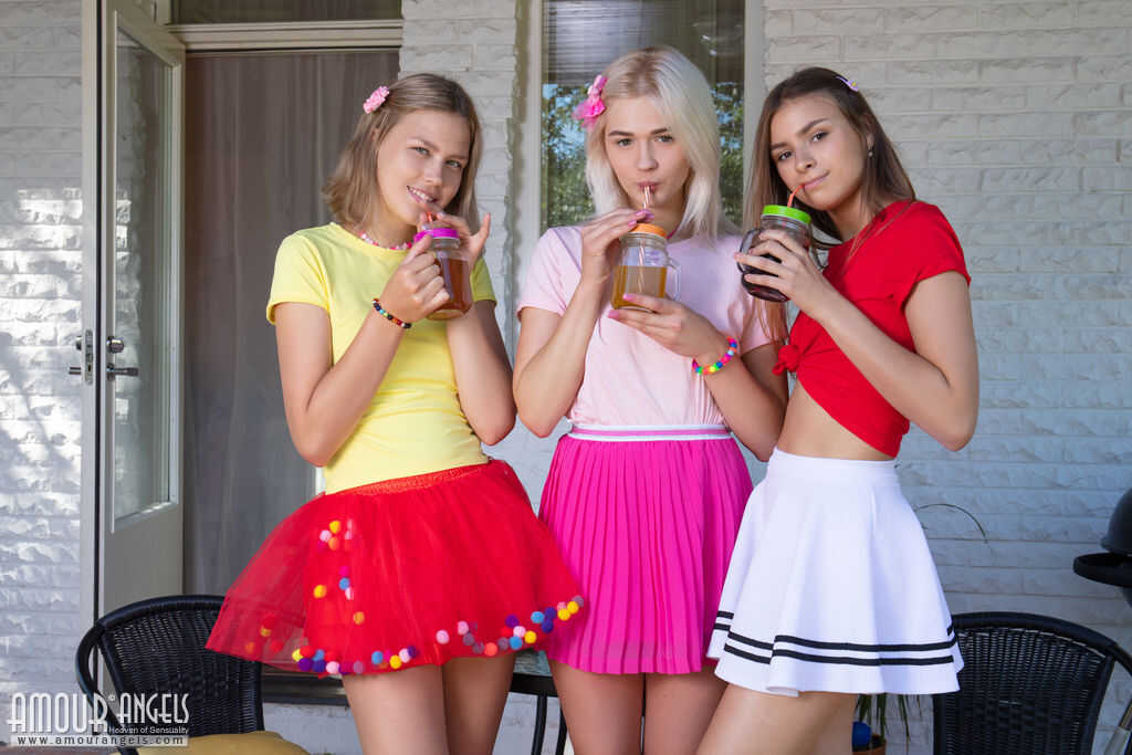 Three young looking girls get naked together after sipping on juice and discovering their sexuality.