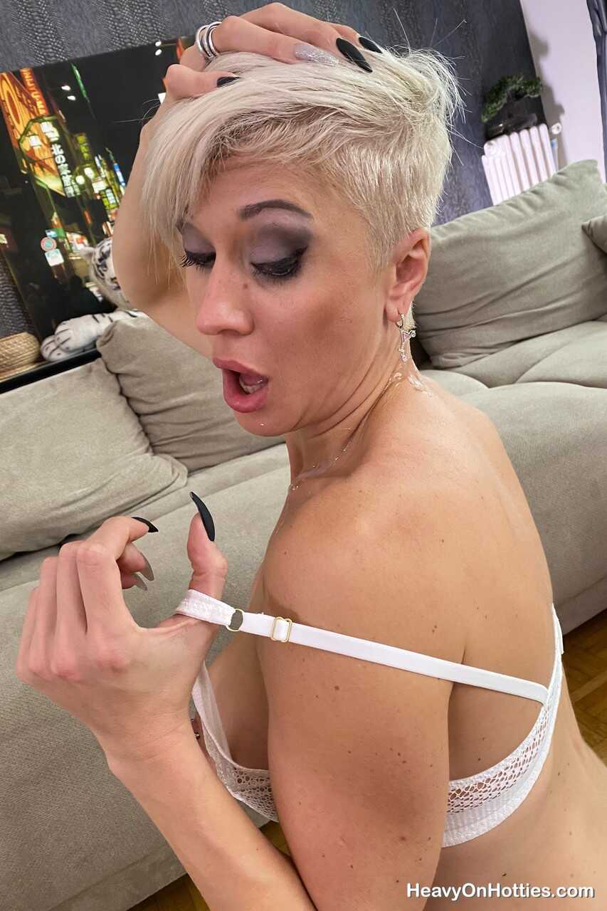 Inked platinum blonde Tanya Virago holds a cock after showing her pierced cunt to your satisfaction . - Tanya Virago