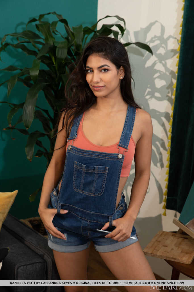 Young and Brunette Daniella Vioti doffs her short overalls for a tight pussy pose - Daniella Vioti