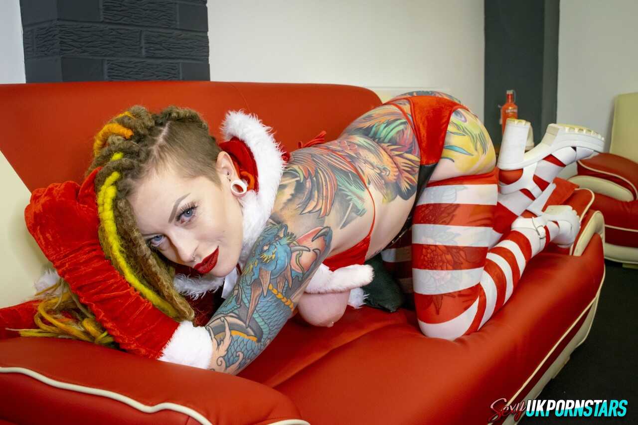 Inked Girl with Brightly Colored Dreadlocks Gets Her Christmas Pussy Filled by Santa Claus!