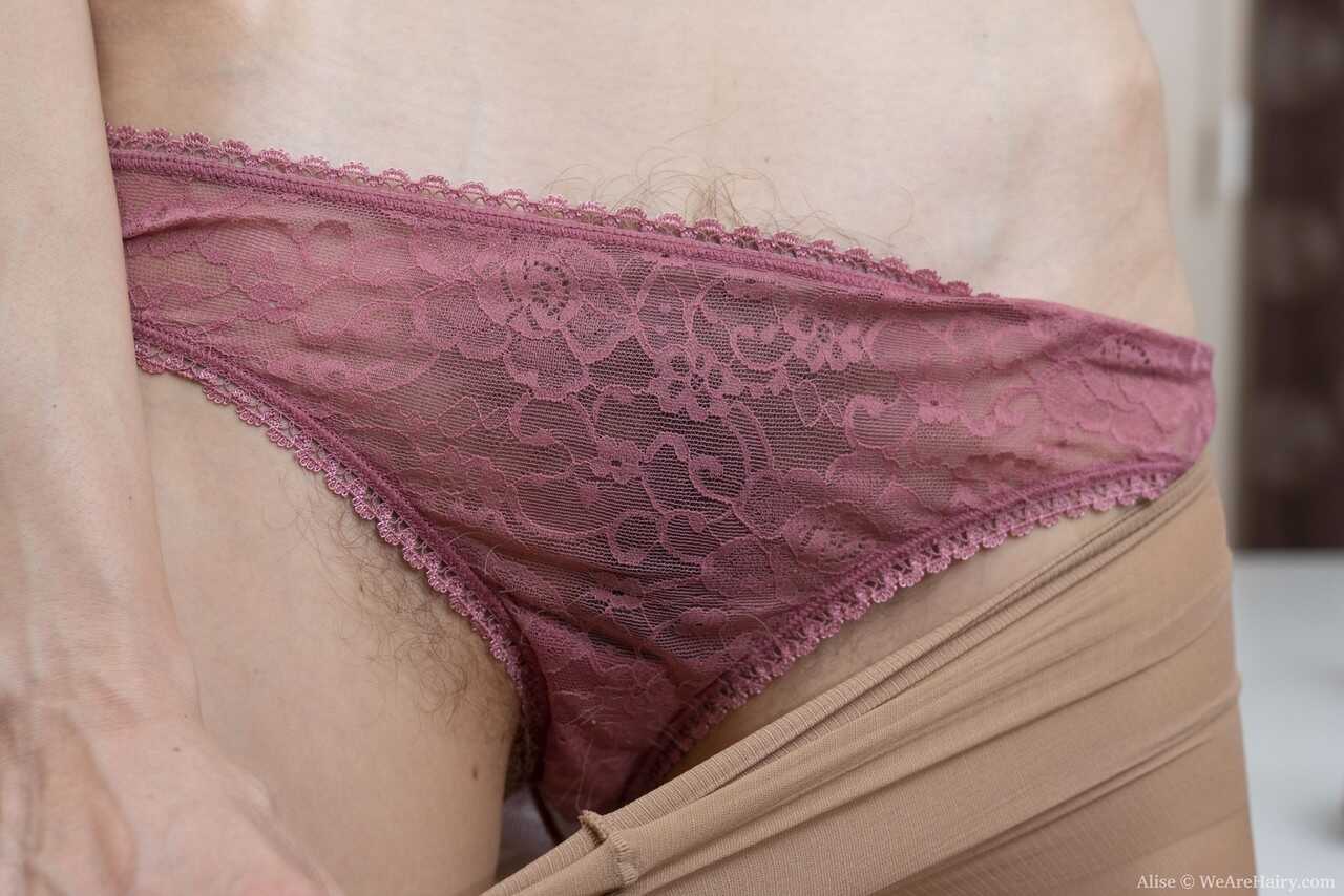 Natural redhead Alise sets her natural vagina free while getting bare naked in skinny pantyhose and see-through lingerie -...