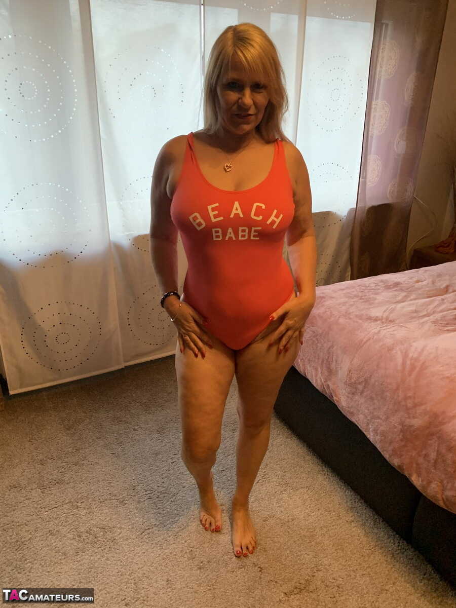 Mature blonde Sweet Susi's big ass bounces on her bed after removing her swimsuit - Sweet Susi
